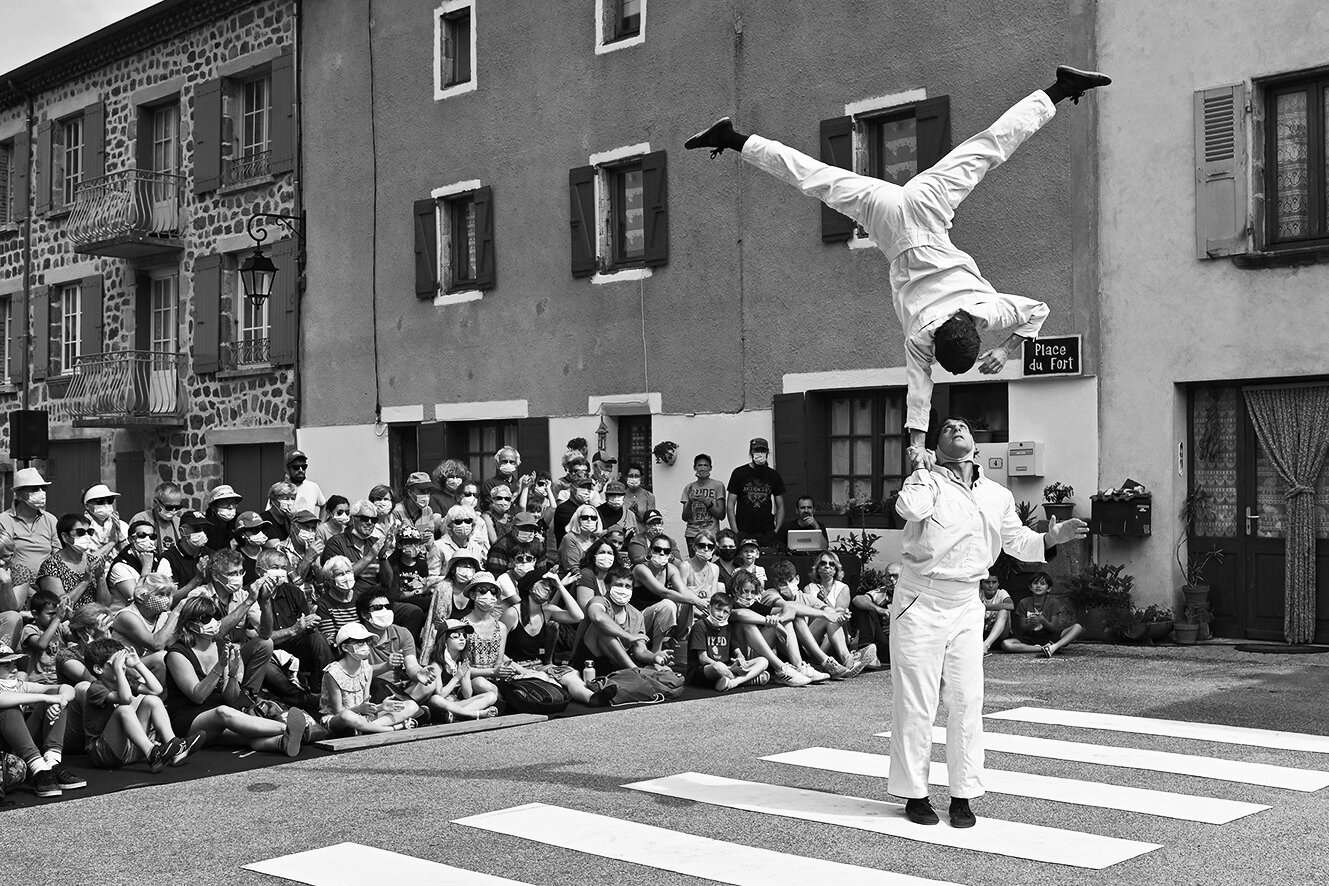Deux artistes réalisent un porté acrobatique dans la rue